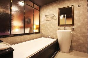 a bathroom with a large tub and a sink at Seoul Ahava Hotel in Seoul +25 photos