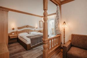 a bedroom with a large bed and a window at Garni Toni in Ortisei