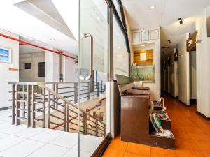 a lobby with a staircase and a couch in a building at California Signature Suites in Sudtungan