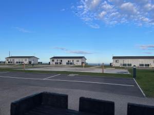an empty parking lot with buildings in the background at Pirates Cove Holiday Chalet in Bridlington