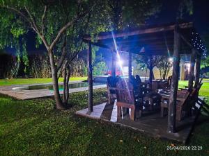 a gazebo with chairs and a table in a park at finca granja la soñadita in Santiago del Estero