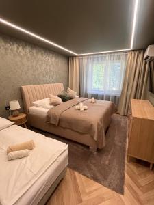 a bedroom with two beds and a window at Apartmán Artemis in Košice