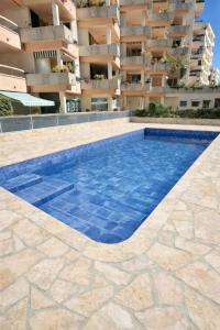 a swimming pool in front of a building at Cozy Studio, Pool & Beaches 2 min away in Roquebrune-Cap-Martin