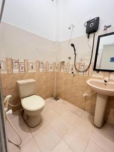 a bathroom with a toilet and a sink at Lumieri Hotel Arugambay in Arugam Bay
