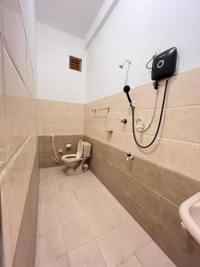 a bathroom with a toilet and a shower at Lumieri Hotel Arugambay in Arugam Bay