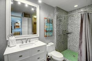 a bathroom with a toilet and a sink and a shower at Bay Tree A3 in Port Aransas