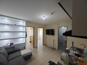 a living room with a couch and a television at Steve's Condo in Davao City