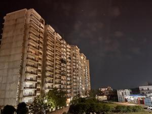 a large apartment building at night with lights at Hogwood in Agra