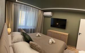a bedroom with a bed with towels on it at Apartmán Artemis in Košice