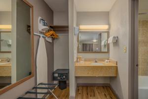 a bathroom with a sink and a mirror at Baymont by Wyndham Socorro in Socorro +32 photos