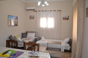 a living room with a couch and a table at Stone-built house Vrontados Chios 3' from beach in Vrontádos