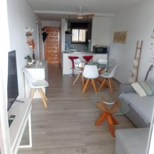a living room with a couch and a table at Oasis Mediterráneo in Ifach +13 photos