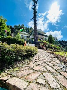 a cobblestone walkway in front of a house at The Plum in Mukteshwar