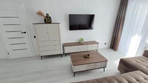 a living room with a couch and a table at Cozy apartment in Šiauliai +7 photos