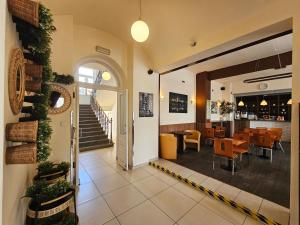 a lobby of a restaurant with a table and chairs at Residence Vysta in Prague