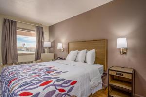 a hotel room with a bed and a window at Baymont by Wyndham Socorro in Socorro