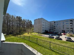 a view of a parking lot from a balcony of a building at Green & Quiet Apartment in Haapsalu in Haapsalu