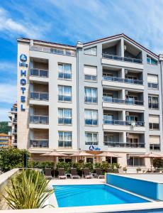 an apartment building with a swimming pool and a hotel at Hotel Idila Budva in Budva