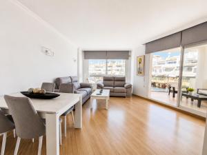 a living room with a table and a couch at G&G Isla Marina Puerto in Benalmádena