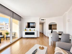 a living room with a couch and a table at G&G Isla Marina Puerto in Benalmádena