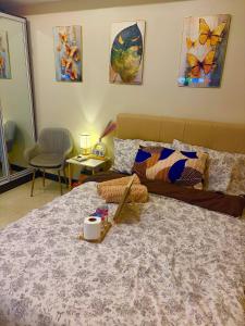 a bedroom with a large bed and a couch at Aurora Escalades in Manila