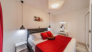 a bedroom with a bed with a red blanket at Villa Anna by Villas Guide in Vela Luka +31 photos