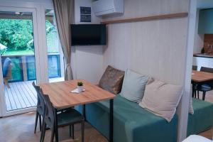 a small living room with a table and a couch at Urban Gardens Ieper in Ieper +47 photos