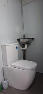 a white toilet with a sink on top of it at Caravan Rustic Sunflower in Mount Crosby