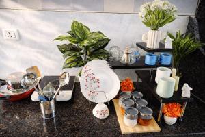 a counter with flowers and other items on it at Oakèra in Agra