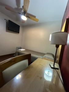 a room with a table and a ceiling fan at Hotel coventry in Santiago del Estero +33 photos