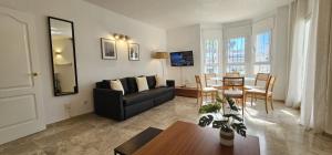 a living room with a black couch and a table at Los Naranjos close to Puerto Banus in Marbella