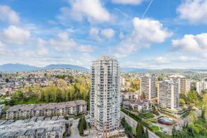 an aerial view of a city with tall buildings at Bright & Cozy 1BR Steps to Brentwood mall in Burnaby