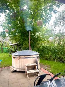 a wooden hot tub with a bench and a smoker at Dock Cottage House in Bădeni +10 photos