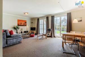 a living room with a couch and a table at Haus Wreechen Ferienwohnung Michaelis in Putbus
