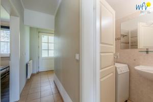 a bathroom with a sink and a white door at Haus Wreechen Ferienwohnung Michaelis in Putbus +15 photos