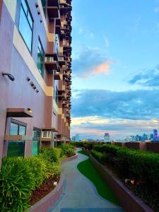 a walkway next to a tall building at Aurora Escalades in Manila