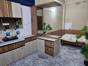 a kitchen with a sink and a table in a room at The Glory Apartment room 1 in Imphal