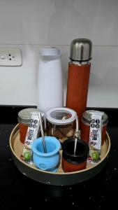 a tray with jars and utensils on a table at Pardelas playa y ballenas in Puerto Madryn
