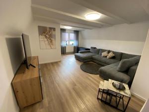 a living room with a couch and a tv at Haus Dani in Oldenburg in Holstein