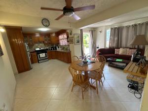 a kitchen and living room with a table and chairs at Glynver Apartments in Christ Church