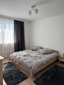 a bedroom with a large bed in a room at Bounty Home in Bistriţa