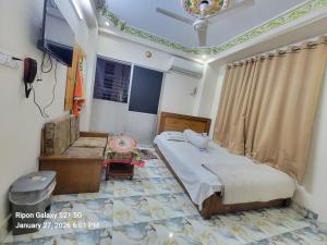 a bedroom with a bed and a chair in it at Hotel Zamzam Residential in Dhaka