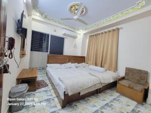 a bedroom with a bed and a ceiling fan at Hotel Zamzam Residential in Dhaka