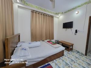 a bedroom with a bed and a flat screen tv at Hotel Zamzam Residential in Dhaka