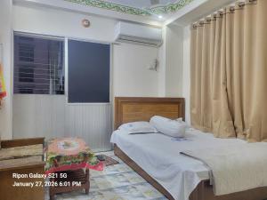 a bedroom with a bed and a window at Hotel Zamzam Residential in Dhaka