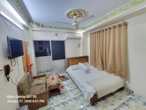 a hospital room with a bed and a television at Hotel Zamzam Residential in Dhaka
