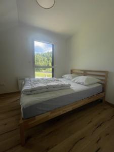 a bedroom with a large bed with a window at Duplex T4 residence les Etoiles du Sud in Le Lioran