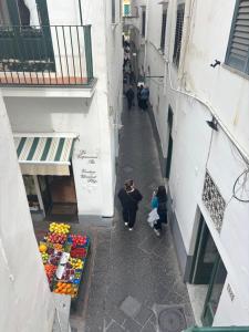 an overhead view of a street with a fruit stand at D&D Lovely central room in Capri