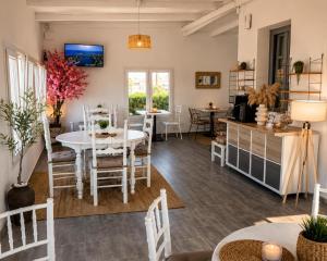 a dining room and living room with a table and chairs at Mare Nostrum Santo in Oia