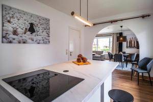 a kitchen with a counter top and a living room at Ferienhaus Inge in Büsum